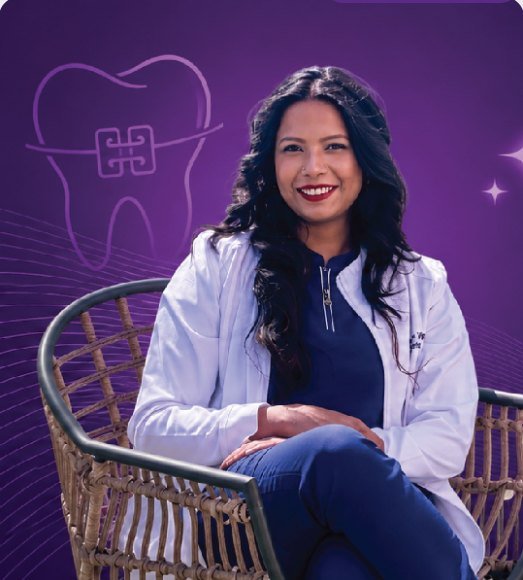 Dr. Shree Vidhya Vijayan seated in her clinic coat